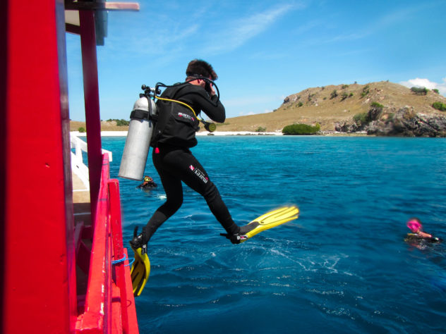 Jumping into the water before swimming with reef sharks at Komodo National Park. 