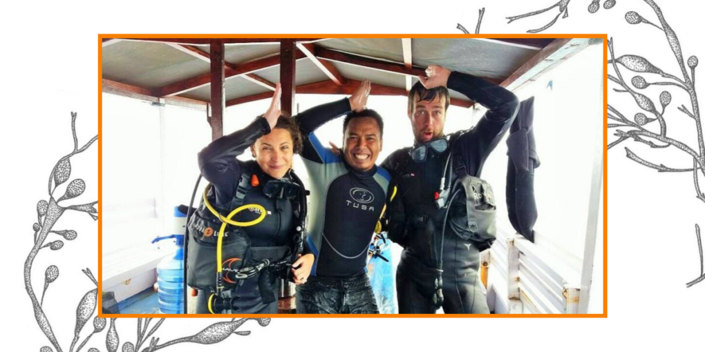 Divers on a boat make the signal for seeing a shark underwater.